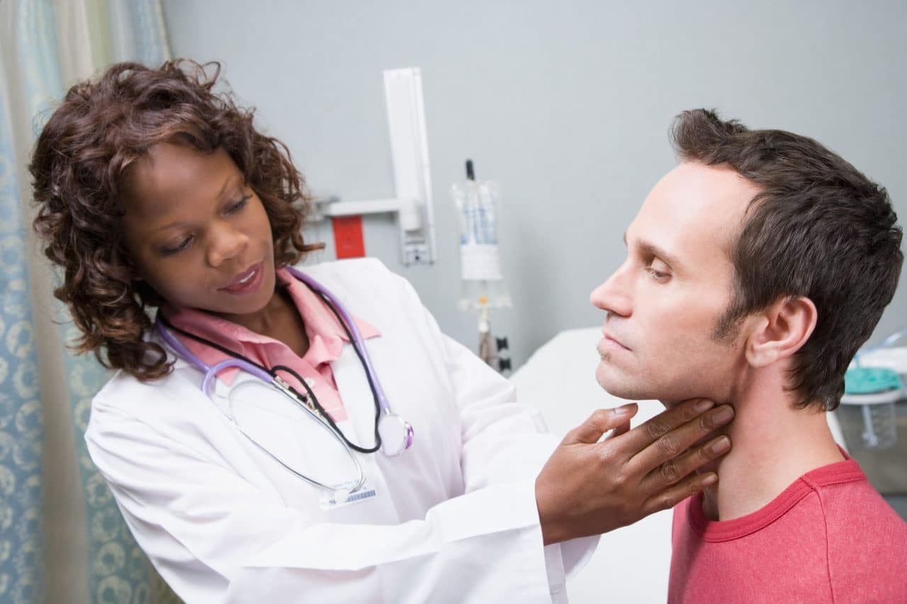 A patient having their throat examined by touch