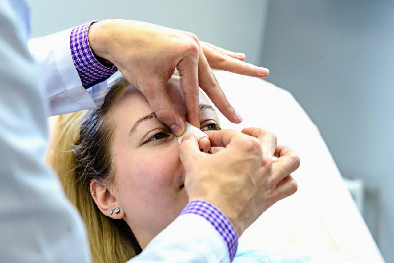 A patient having a splint wrapped around their nose