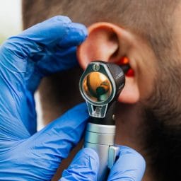 Doctor gives patient an ear exam.