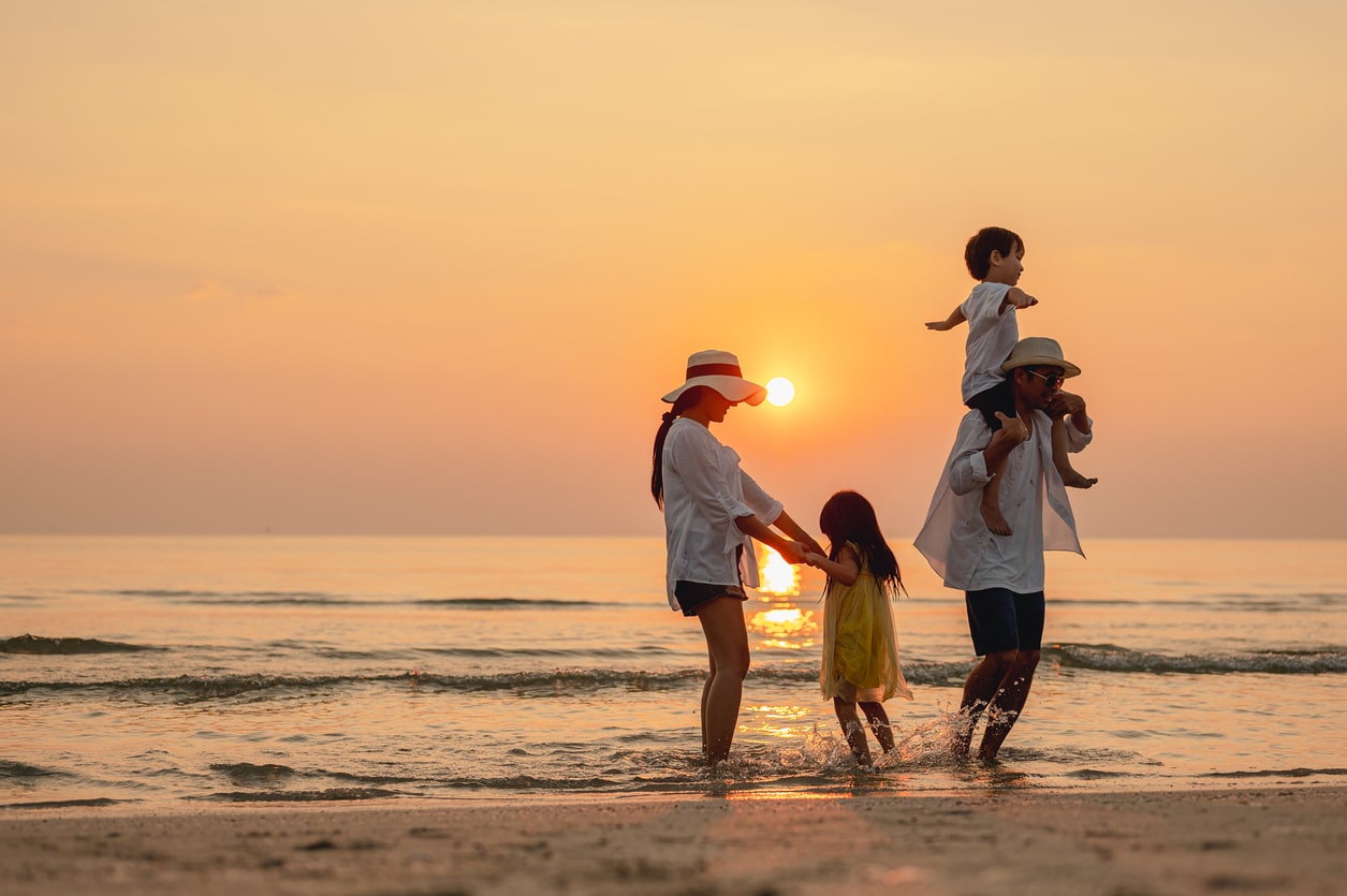 Happy family spending a summer day at the beach.