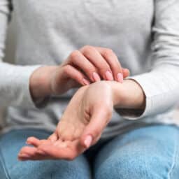 Woman scratching an itch on her wrist