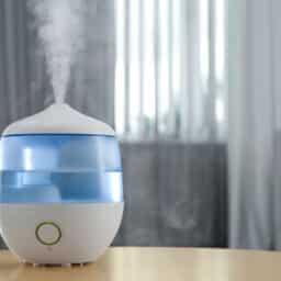 Humidifier on a table emitting water vapor into the air.